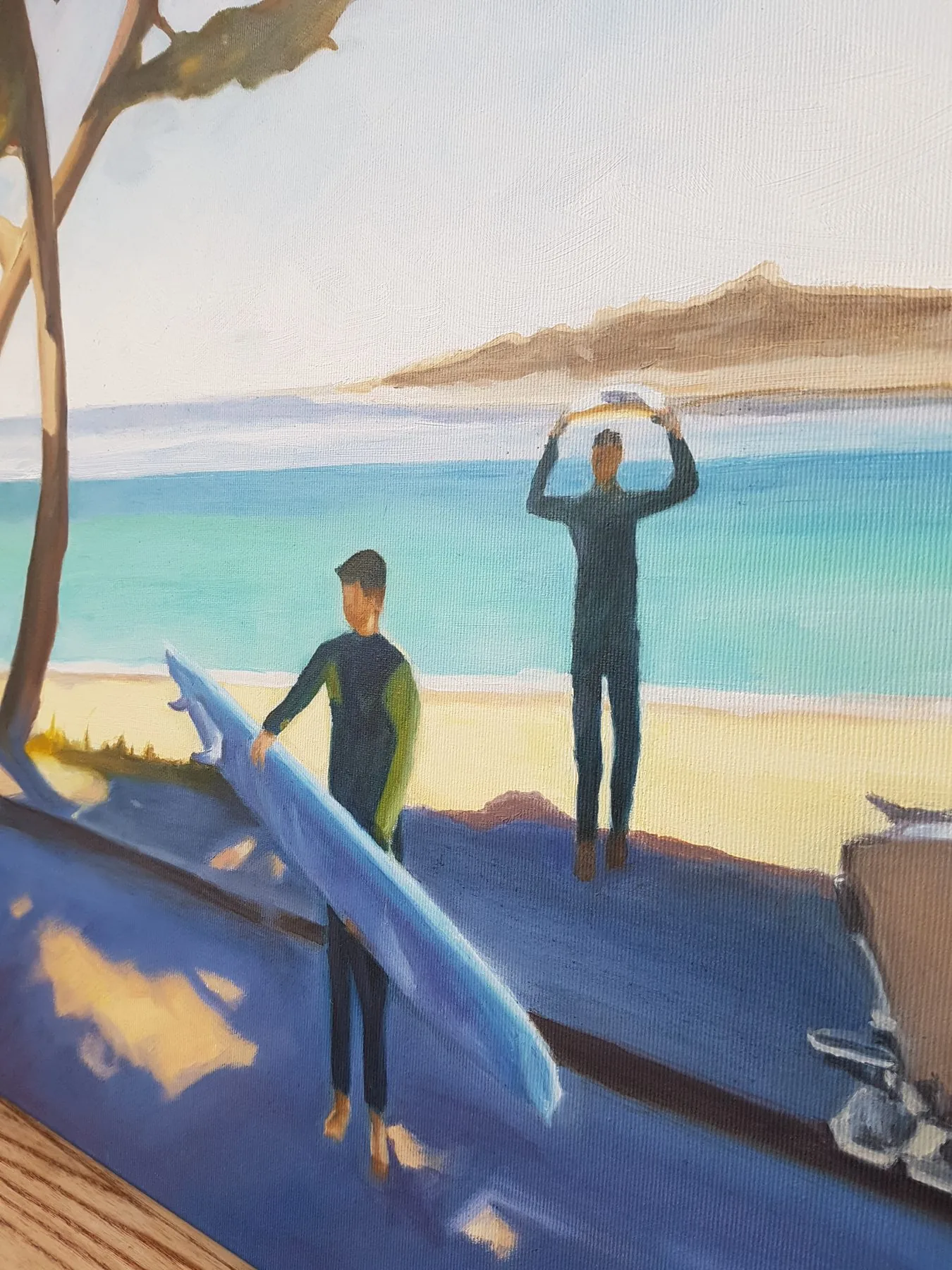 Close-up of two surfers with boards on a sunny beach