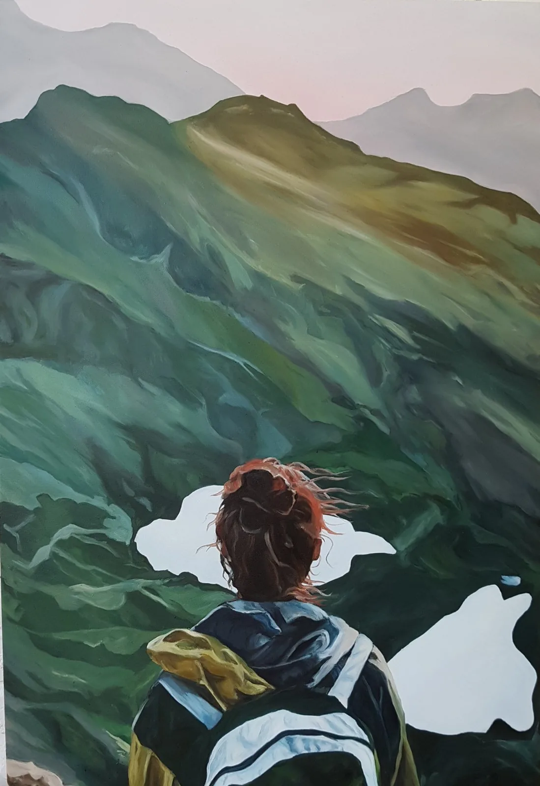 Girl in Mountains — A hiker with wind-blown hair looking over green ridges and mountain lakes